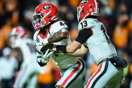 Nov 13, 2021; Knoxville, Tennessee, USA; Georgia Bulldogs running back James Cook (4) takes a hand off from quarterback Stetson Bennett (13) during the third quarter in a game against the Tennessee Volunteers at Neyland Stadium. Mandatory Credit: Bryan Lynn-USA TODAY Sports