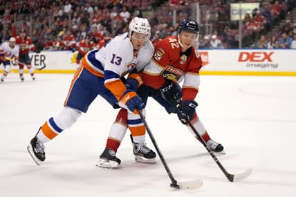 Nov 16, 2021; Sunrise, Florida, USA; New York Islanders center Mathew Barzal (13) and Florida Panthers defenseman Gustav Forsling (42) battle for the puck during the first period at FLA Live Arena. Mandatory Credit: Jasen Vinlove-USA TODAY Sports