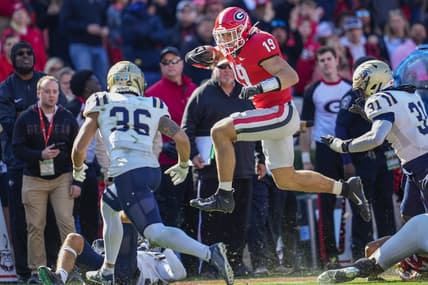 Nov 20, 2021; Athens, Georgia, USA; Georgia Bulldogs tight end Brock Bowers (19) jumps over Charleston Southern Buccaneers tacklers during the first quarter at Sanford Stadium. Mandatory Credit: Dale Zanine-USA TODAY Sports