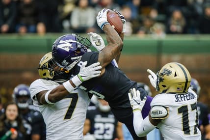 Nov 20, 2021; Chicago, Illinois, USA; Northwestern Wildcats wide receiver Malik Washington (6) catches the ball while defended by Purdue Boilermakers cornerback Jamari Brown (7) and safety Chris Jefferson (17) during the second quarter at Wrigley Field. Mandatory Credit: Jon Durr-USA TODAY Sports