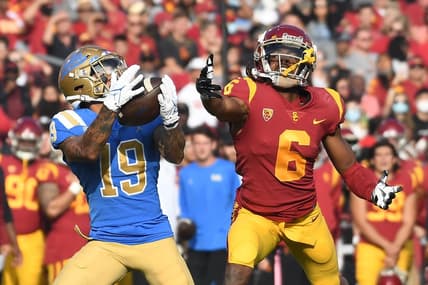 Nov 20, 2021; Los Angeles, California, USA;  UCLA Bruins running back Kazmeir Allen (19) catches a touchdown pass against Southern California Trojans cornerback Isaac Taylor-Stuart (6) in the first half at the Los Angeles Memorial Coliseum. Mandatory Credit: Richard Mackson-USA TODAY Sports