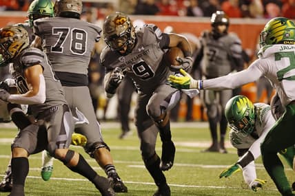 Nov 20, 2021; Salt Lake City, Utah, USA; Utah Utes running back Tavion Thomas (9) runs for a first quarter touchdown against the Oregon Ducks at Rice-Eccles Stadium. Mandatory Credit: Jeffrey Swinger-USA TODAY Sports
