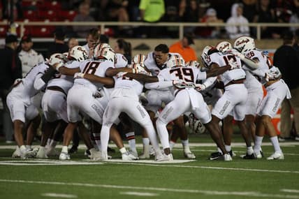 Nov 20, 2021; Lubbock, Texas, USA;  The Oklahoma State Cowboys huddle before a game against the Texas Tech Red Raiders at Jones AT&T Stadium. Mandatory Credit: Michael C. Johnson-USA TODAY Sports