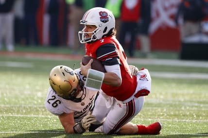 Nov 26, 2021; Salt Lake City, Utah, USA; Utah Utes quarterback Cameron Rising (7) tries for the first down against Colorado Buffaloes linebacker Carson Wells (26) in the second quarter at Rice-Eccles Stadium. Mandatory Credit: Jeffrey Swinger-USA TODAY Sports