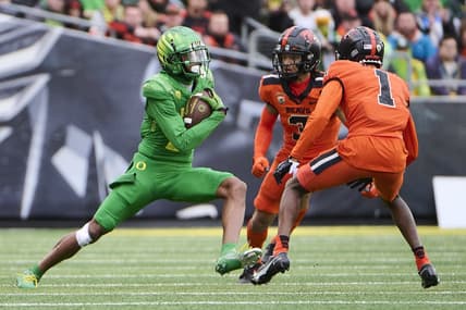 Nov 27, 2021; Eugene, Oregon, USA; Oregon Ducks wide receiver Devon Williams (2) catches a pass for a first down against Oregon State Beavers defensive back Jaydon Grant (3) and defensive back Rejzohn Wright (1) at Autzen Stadium. Mandatory Credit: Troy Wayrynen-USA TODAY Sports