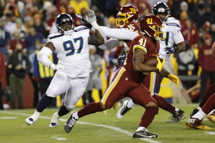 Nov 29, 2021; Landover, Maryland, USA; Washington Football Team running back J.D. McKissic (41) carries the ball past Seattle Seahawks defensive tackle Poona Ford (97) during the first quarter at FedExField. Mandatory Credit: Geoff Burke-USA TODAY Sports