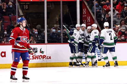 Nov 29, 2021; Montreal, Quebec, CAN; Vancouver Canucks right wing Conor Garland (8) celebrates his goal against Montreal Canadiens with teammates during the second period at Bell Centre. Mandatory Credit: Jean-Yves Ahern-USA TODAY Sports