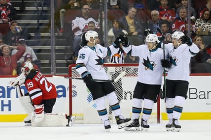 Nov 30, 2021; Newark, New Jersey, USA; San Jose Sharks defenseman Erik Karlsson (65) celebrates with left wing Alexander Barabanov (94) and left wing Rudolfs Balcers (92) after scoring a goal against New Jersey Devils during the second period at Prudential Center. Mandatory Credit: Tom Horak-USA TODAY Sports