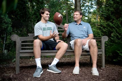 Christ School senior quarterback Navy Shuler and his dad, former NFL quarterback Heath Shuler, in the backyard of their home on July 2, 2019. 

Tab Shuler 02