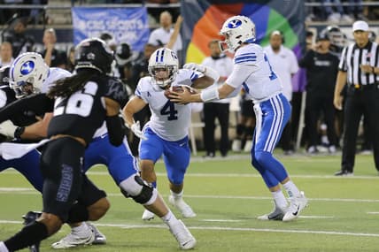 Oct 1, 2021; Logan, Utah, USA; Brigham Young Cougars quarterback Baylor Romney (16) hands the ball off to running back Lopini Katoa (4) during the first quarter against the Utah State Aggies at Merlin Olsen Field at Maverik Stadium. Mandatory Credit: Rob Gray-USA TODAY Sports
