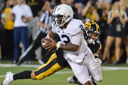 Oct 9, 2021; Iowa City, Iowa, USA; Penn State Nittany Lions quarterback Ta'Quan Roberson (2) eludes the tackle of Iowa Hawkeyes defensive back Dane Belton (4) during the fourth quarter at Kinnick Stadium. Mandatory Credit: Jeffrey Becker-USA TODAY Sports