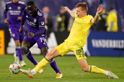Nashville SC defender Alistair Johnston (12) defends against Orlando City forward Benji Michel (19) during the second half of an MLS playoff soccer match at Nissan Stadium in Nashville, Tenn., Tuesday, Nov. 23, 2021.

Nsc Oc Mls 112321 Aan 023