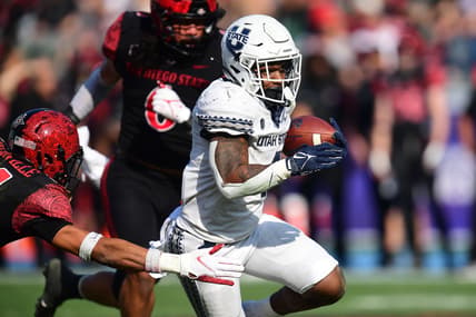 Dec 4, 2021; Carson, CA, USA; Utah State Aggies running back Calvin Tyler Jr. (4) runs the ball against San Diego State Aztecs safety C.J. Baskerville (34) during the first half of the Mountain West Conference championship game at Dignity Health Sports Park. Mandatory Credit: Gary A. Vasquez-USA TODAY Sports