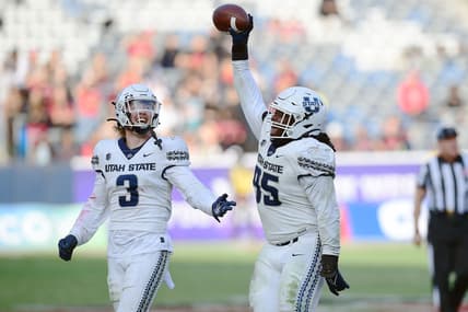 Dec 4, 2021; Carson, CA, USA; Utah State Aggies defensive tackle Marcus Moore (95) and linebacker Justin Rice (3) celebrate the fumble recovery against the San Diego State Aztecs during the second half of the Mountain West Conference championship game at Dignity Health Sports Park. Mandatory Credit: Gary A. Vasquez-USA TODAY Sports
