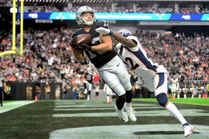Dec 26, 2021; Paradise, Nevada, USA; Las Vegas Raiders wide receiver Hunter Renfrow (13) makes a touchdown catch against Denver Broncos safety Kareem Jackson (22) during the first half at Allegiant Stadium. Mandatory Credit: Joe Camporeale-USA TODAY Sports