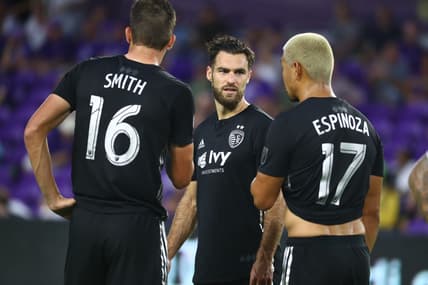 Aug 14, 2019; Orlando, FL, USA; Sporting Kansas City midfielder Graham Zusi (8), midfielder Graham Smith (16) and midfielder Roger Espinoza (17) talk against the Orlando City SC during the first half at Exploria Stadium. Mandatory Credit: Kim Klement-USA TODAY Sports