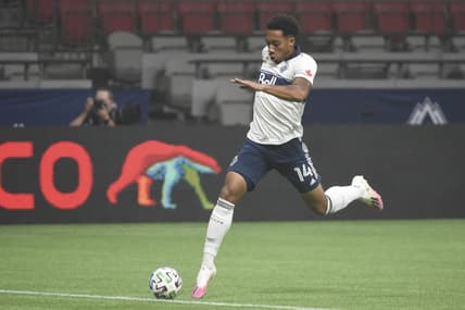 Sep 13, 2020; Vancouver, British Columbia, CAN; Vancouver Whitecaps midfielder Theo Bair (14) reaches for the ball against the Montreal Impact during the first half at BC Place. Mandatory Credit: Anne-Marie Sorvin-USA TODAY Sports