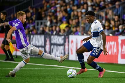 Aug 26, 2021; Victoria, British Columbia, Canada;  Pacific FC forward Josh Heard (11) reaches for the ball against Vancouver Whitecaps defender Javain Brown (23) during the second half at the Starlight Stadium. Mandatory Credit: Anne-Marie Sorvin-USA TODAY Sports