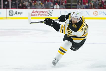 Oct 28, 2021; Raleigh, North Carolina, USA; Boston Bruins defenseman Matt Grzelcyk (48) takes a slap shot during the third period against the Carolina Hurricanes at PNC Arena. Mandatory Credit: James Guillory-USA TODAY Sports