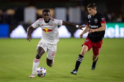 Oct 27, 2021; Washington, District of Columbia, USA; New York Red Bulls midfielder Dru Yearwood (16) dribbles the ball as D.C. United defender Frederic Brillant (13) defends during the second half at Audi Field. Mandatory Credit: Scott Taetsch-USA TODAY Sports