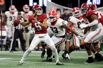 Dec 4, 2021; Atlanta, GA, USA; Alabama Crimson Tide quarterback Bryce Young (9) attempts a pass against Georgia Bulldogs linebacker Robert Beal Jr. (33) during the second quarter of the SEC championship game at Mercedes-Benz Stadium. Mandatory Credit: Jason Getz-USA TODAY Sports