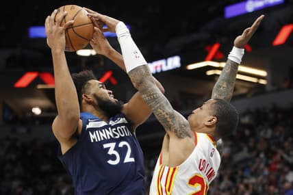 Dec 6, 2021; Minneapolis, Minnesota, USA; Minnesota Timberwolves center Karl-Anthony Towns (32) works to the basket as Atlanta Hawks forward John Collins (20) defends him in the third quarter at Target Center. Mandatory Credit: Bruce Kluckhohn-USA TODAY Sports