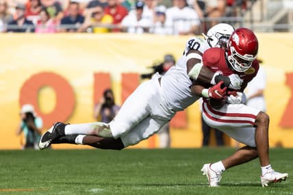 Jan 1, 2022; Tampa, FL, USA; Penn State Nittany Lions linebacker Jesse Luketa (40) tackles Arkansas Razorbacks wide receiver Bryce Stephens (14) during the first half during the 2022 Outback Bowl at Raymond James Stadium. Mandatory Credit: Matt Pendleton-USA TODAY Sports