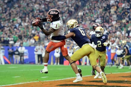 Jan 1, 2022; Glendale, Arizona, USA; Oklahoma State Cowboys wide receiver Tay Martin (1) catches a touchdown pass against Notre Dame Fighting Irish cornerback Clarence Lewis (6) during the second half of the 2022 Fiesta Bowl at State Farm Stadium. Mandatory Credit: Joe Camporeale-USA TODAY Sports