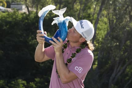 January 9, 2022; Maui, Hawaii, USA; Cameron Smith kisses the trophy after winning during the final round of the Sentry Tournament of Champions golf tournament at Kapalua Resort - The Plantation Course. Mandatory Credit: Kyle Terada-USA TODAY Sports