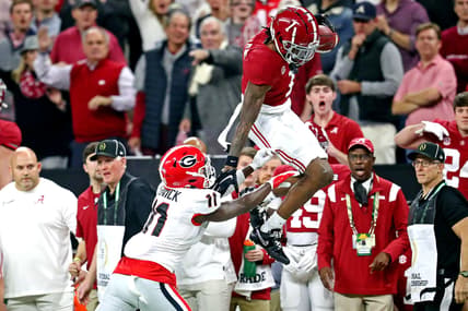 Jan 10, 2022; Indianapolis, IN, USA; Alabama Crimson Tide wide receiver Jameson Williams (1) tries to jumps over Georgia Bulldogs defensive back Derion Kendrick (11) during the first quarter in the 2022 CFP college football national championship game at Lucas Oil Stadium. Mandatory Credit: Mark J. Rebilas-USA TODAY Sports