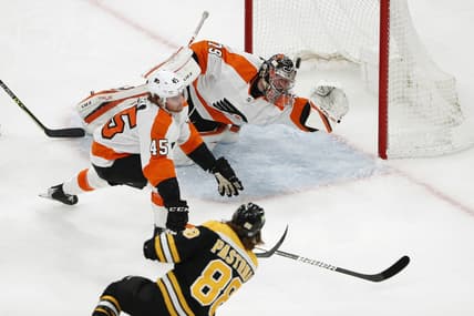 Jan 13, 2022; Boston, Massachusetts, USA; Boston Bruins right wing David Pastrnak (88) scores a goal past Philadelphia Flyers goaltender Carter Hart (79) and defenseman Cam York (45) during the first period at TD Garden. Mandatory Credit: Winslow Townson-USA TODAY Sports