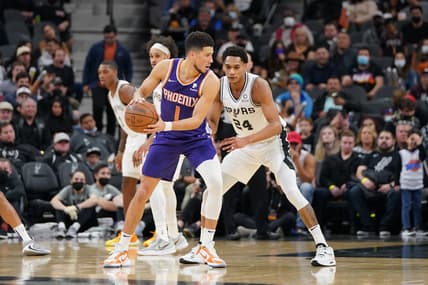 Jan 17, 2022; San Antonio, Texas, USA;  Phoenix Suns guard Devin Booker (1) backs into San Antonio Spurs guard Devin Vassell (24) in the second half at the AT&T Center. Mandatory Credit: Daniel Dunn-USA TODAY Sports