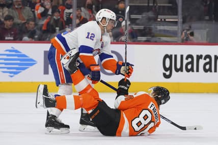 Jan 18, 2022; Philadelphia, Pennsylvania, USA; New York Islanders right wing Josh Bailey (12) checks Philadelphia Flyers left wing Joel Farabee (86) in the second period at the Wells Fargo Center. Mandatory Credit: Mitchell Leff-USA TODAY Sports