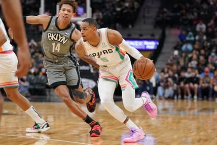 Jan 21, 2022; San Antonio, Texas, USA;  San Antonio Spurs guard Dejounte Murray (5) drives past Brooklyn Nets forward Kessler Edwards (14) in the first half at the AT&T Center. Mandatory Credit: Daniel Dunn-USA TODAY Sports