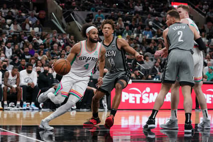 Jan 21, 2022; San Antonio, Texas, USA;  San Antonio Spurs guard Derrick White (4) drives past Brooklyn Nets forward Kessler Edwards (14) in the first half at the AT&T Center. Mandatory Credit: Daniel Dunn-USA TODAY Sports