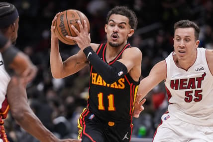 Jan 21, 2022; Atlanta, Georgia, USA; Atlanta Hawks guard Trae Young (11) controls the ball against Miami Heat guard Duncan Robinson (55) during the second half at State Farm Arena. Mandatory Credit: Dale Zanine-USA TODAY Sports