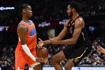 Jan 22, 2022; Cleveland, Ohio, USA; Cleveland Cavaliers center Evan Mobley (4) and Oklahoma City Thunder guard Shai Gilgeous-Alexander (2) fight for a loose ball during the second half at Rocket Mortgage FieldHouse. Mandatory Credit: Ken Blaze-USA TODAY Sports