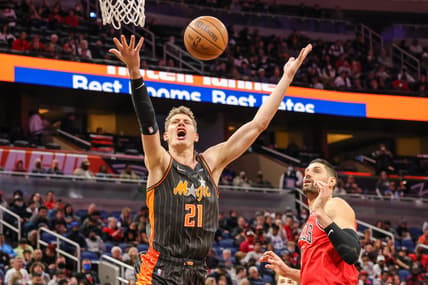 Jan 23, 2022; Orlando, Florida, USA; Orlando Magic center Moritz Wagner (21) reacts to a foul by Chicago Bulls center Nikola Vucevic (9) during the first quarter at Amway Center. Mandatory Credit: Mike Watters-USA TODAY Sports
