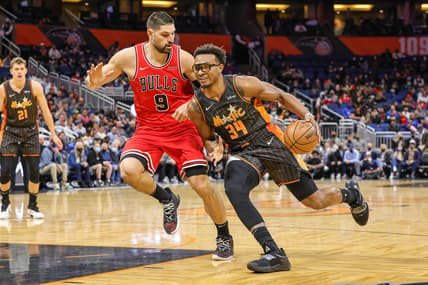 Jan 23, 2022; Orlando, Florida, USA; Orlando Magic center Wendell Carter Jr. (34) moves to the basket against Chicago Bulls center Nikola Vucevic (9) during the first quarter at Amway Center. Mandatory Credit: Mike Watters-USA TODAY Sports