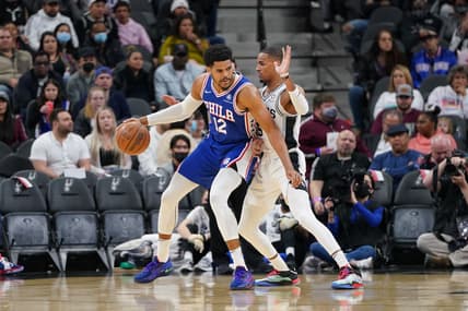 Jan 23, 2022; San Antonio, Texas, USA;  Philadelphia 76ers forward Tobias Harris (12) backs in against San Antonio Spurs guard Dejounte Murray (5) in the first half at the AT&T Center. Mandatory Credit: Daniel Dunn-USA TODAY Sports