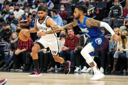 Jan 23, 2022; Minneapolis, Minnesota, USA; Brooklyn Nets guard Patty Mills (8) dribbles past Minnesota Timberwolves guard D'Angelo Russell (0) during the first quarter at Target Center. Mandatory Credit: Brace Hemmelgarn-USA TODAY Sports