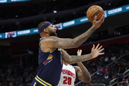 Jan 25, 2022; Detroit, Michigan, USA;  Denver Nuggets center DeMarcus Cousins (4) shoots on Detroit Pistons center Isaiah Stewart (28) in the first half at Little Caesars Arena. Mandatory Credit: Rick Osentoski-USA TODAY Sports