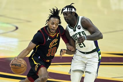 Jan 26, 2022; Cleveland, Ohio, USA; Cleveland Cavaliers guard Darius Garland (10) drives against Milwaukee Bucks guard Jrue Holiday (21) in the first quarter at Rocket Mortgage FieldHouse. Mandatory Credit: David Richard-USA TODAY Sports