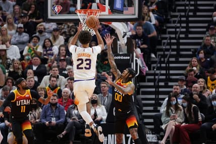 Jan 26, 2022; Salt Lake City, Utah, USA;  Phoenix Suns forward Cameron Johnson (23) pushes the ball past Utah Jazz guard Jordan Clarkson (00) and to the basket during the second quarter at Vivint Arena. Mandatory Credit: Chris Nicoll-USA TODAY Sports