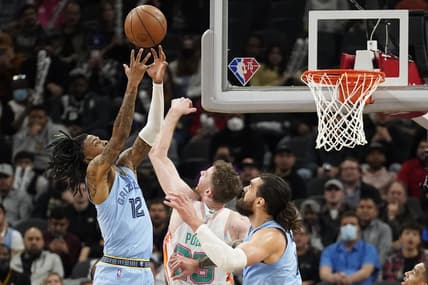 Jan 26, 2022; San Antonio, Texas, USA; Memphis Grizzlies guard Ja Morant (12) shoots over San Antonio Spurs center Jakob Poeltl (25) during the second half at AT&T Center. Mandatory Credit: Scott Wachter-USA TODAY Sports