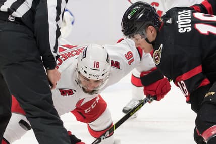 Jan 27, 2022; Ottawa, Ontario, CAN; Carolina Hurricanes cente Vincent Trocheck (16) faces off against Ottawa Senators left wing Tim St tzle (18) in the second period at the Canadian Tire Centre. Mandatory Credit: Marc DesRosiers-USA TODAY Sports