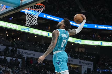 Jan 28, 2022; Charlotte, North Carolina, USA; Charlotte Hornets forward Miles Bridges (0) makes a fast break dunk against the Los Angeles Lakers during the second half at the Spectrum Center. Mandatory Credit: Jim Dedmon-USA TODAY Sports