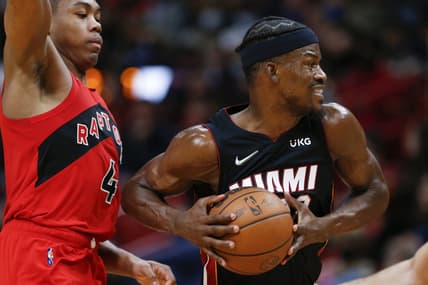 Jan 29, 2022; Miami, Florida, USA; Miami Heat forward Jimmy Butler (22) protects the ball from Toronto Raptors forward Scottie Barnes (4) during the second quarter at FTX Arena. Mandatory Credit: Sam Navarro-USA TODAY Sports