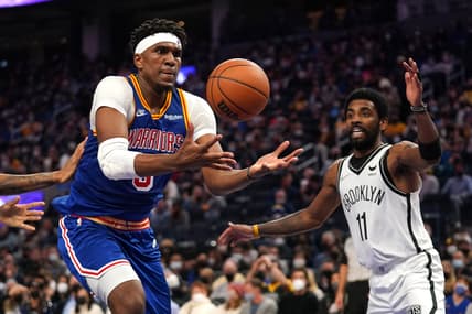Jan 29, 2022; San Francisco, California, USA; Golden State Warriors forward Kevon Looney (5) grabs a rebound against Brooklyn Nets guard Kyrie Irving (11) in the second quarter at the Chase Center. Mandatory Credit: Cary Edmondson-USA TODAY Sports