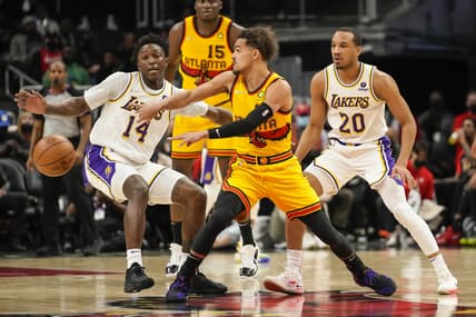 Jan 30, 2022; Atlanta, Georgia, USA; Atlanta Hawks guard Trae Young (11) passes the ball past Los Angeles Lakers forward Stanley Johnson (14) during the first half at State Farm Arena. Mandatory Credit: Dale Zanine-USA TODAY Sports